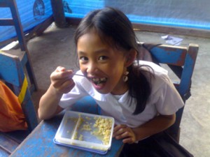 little Philippine girl eating