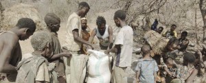 African people getting bags of food