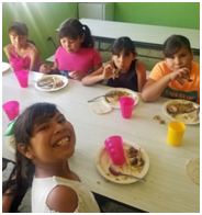 little girls eating and smiling