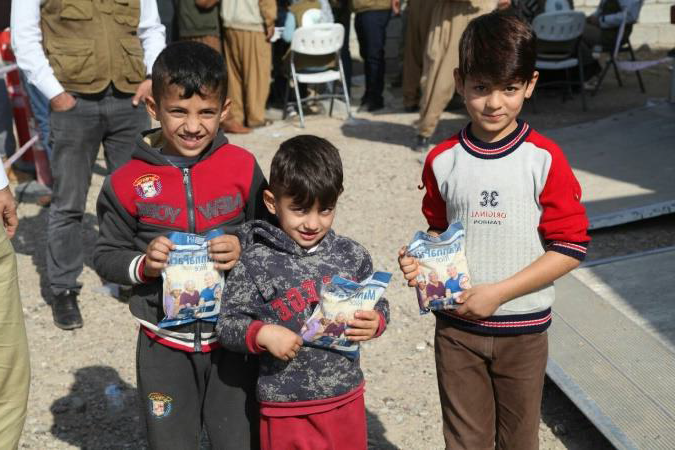 Three boys with food packets