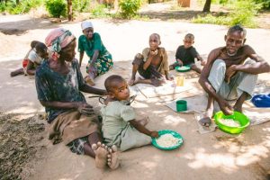 Group of Malawi villagers eating rice